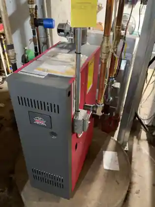 Crown hydronic boiler photographed during a homeowner pre-service inspection