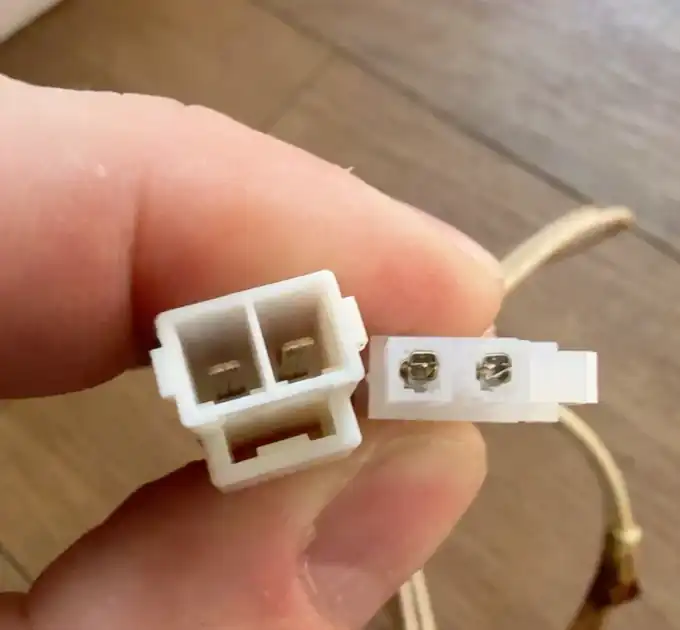 Close-up of two incompatible two-pin oven igniter connector housings