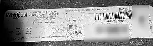 Whirlpool WFG505M0MS0 model and serial label found on the left inside wall of the lower drawer opening